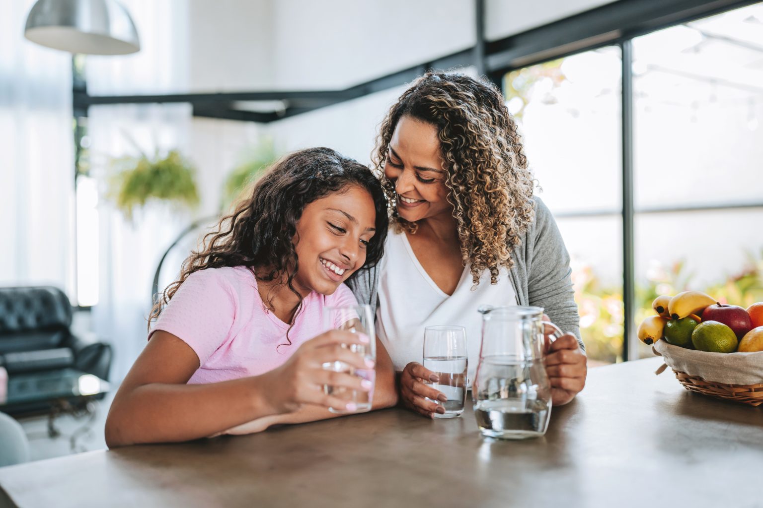 Mother and daughter drinking water together